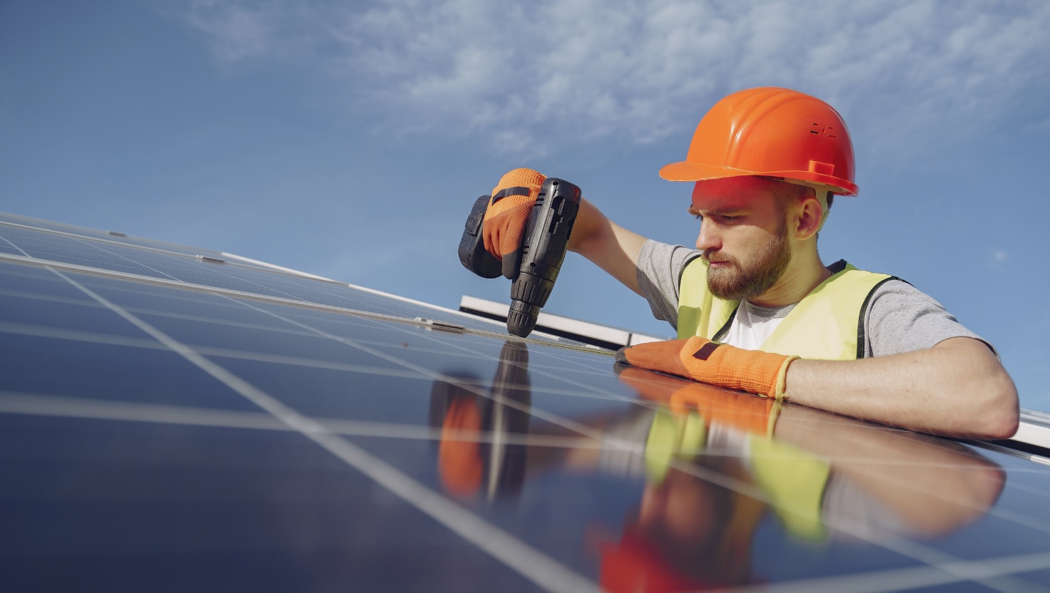 man installing solar panels