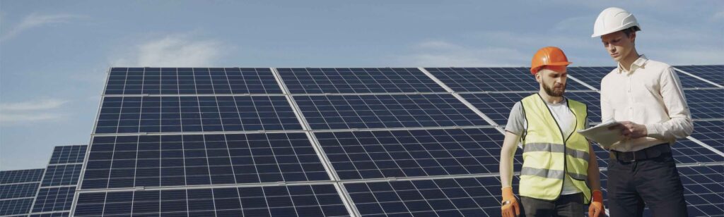 engineers working outside by solar panels